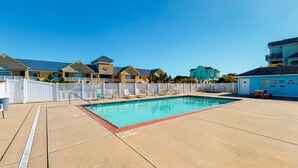 A pool area with a 'No Diving' sign, lounge chairs, and a fence. - Family Condo w/Free WiFi, Central AC, Shared Pool, Private Washer/Dryer (Hatteras)