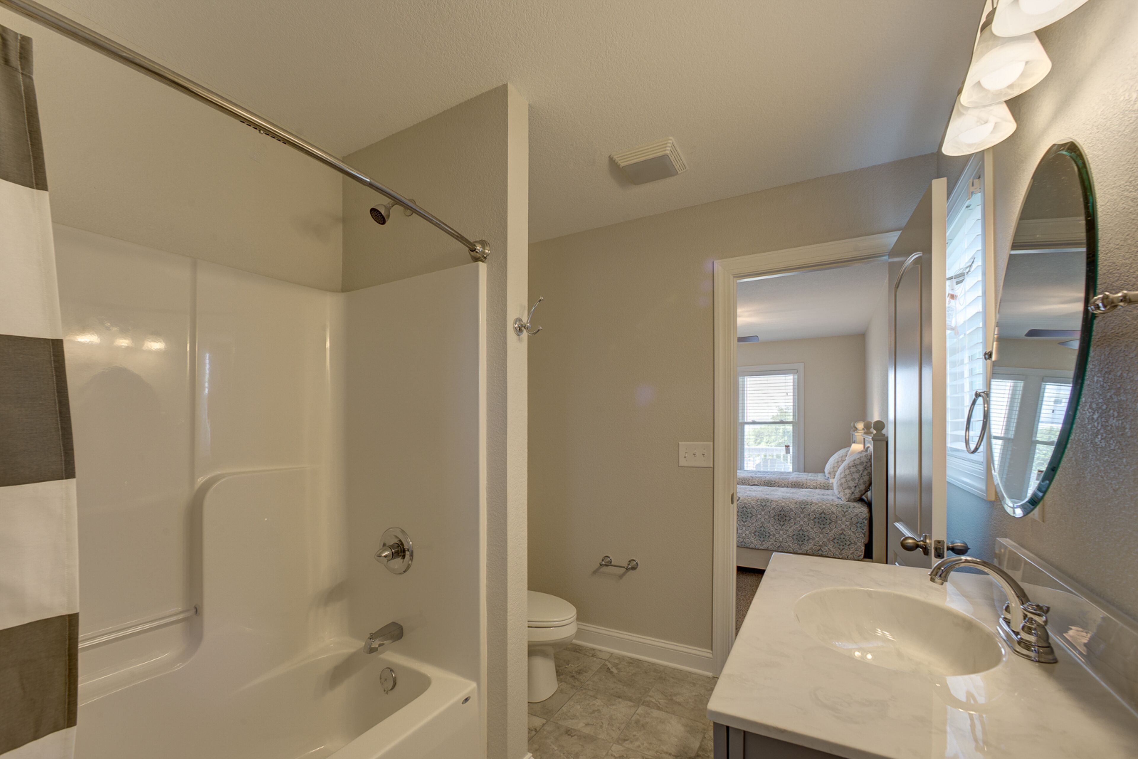 A bathroom with a bathtub, toilet, and sink.