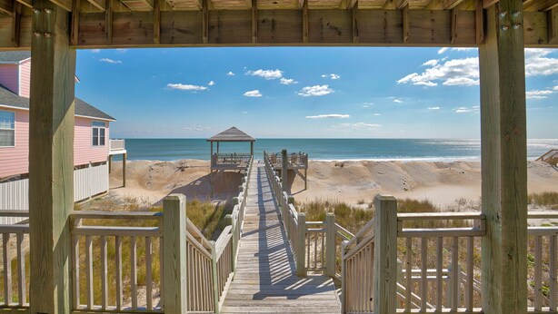 A wooden boardwalk leading to a beach with a gazebo, overlooking the ocean. - Oceanfront home with great views, central AC, washer/dryer, beach access (North Topsail Beach)