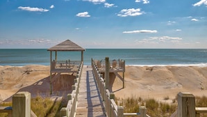 A wooden boardwalk leading to a beach with a wooden structure at the end. - Oceanfront home with great views, central AC, washer/dryer, beach access (North Topsail Beach)