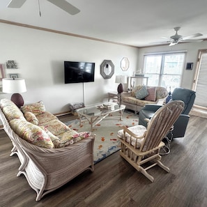 A living room with a sofa, armchair, and a coffee table.