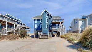 A beachfront building with multiple balconies and a gated entrance. - Oceanfront Retreat, Stunning Views, Renovated Spaces, Game Room with Pool Table (Avon)