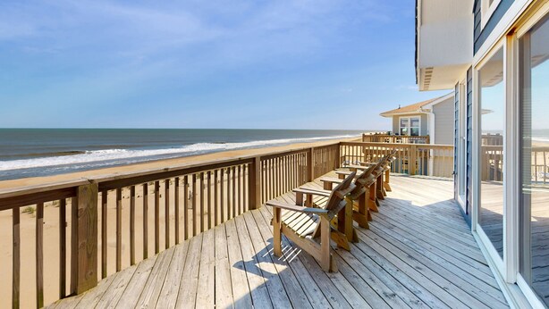 A wooden deck with outdoor seating overlooking the ocean. - Oceanfront Retreat, Stunning Views, Renovated Spaces, Game Room with Pool Table (Avon)