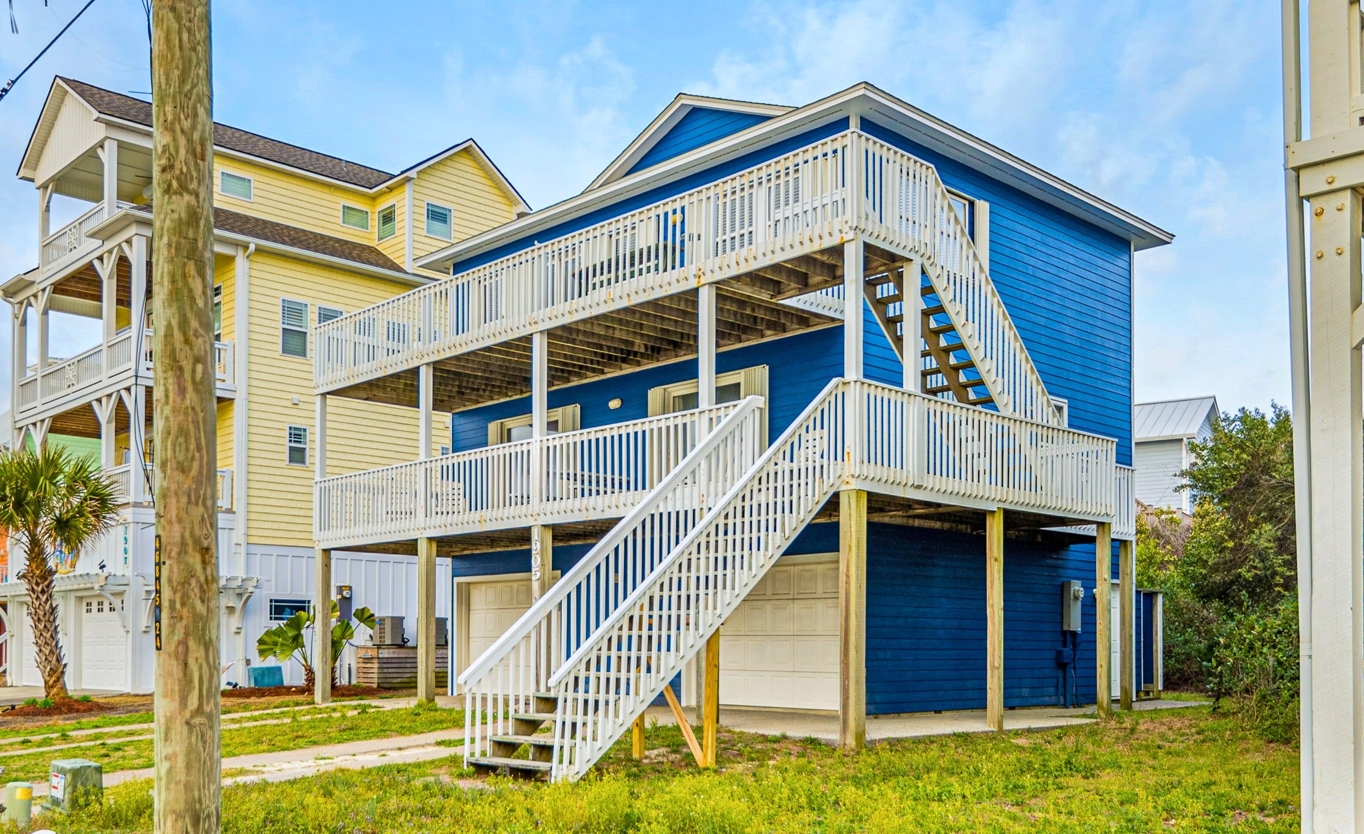 A two-story house with a balcony and a staircase leading to the upper floor.
