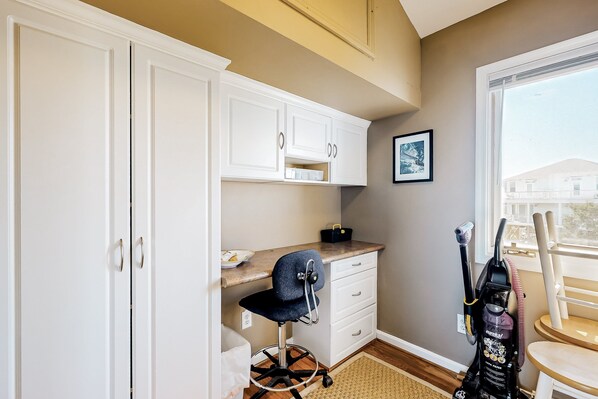 A compact office space with a desk, chair, and storage cabinets. - Sound front retreat with easy beach access, sauna and private dock for your boat! (Surf City)