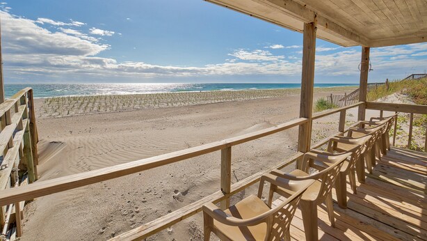 A beachside pavilion with wooden benches and a view of the ocean. - 3BR Oceanfront Topsail Beach Cottage | Dog Friendly! (Topsail Beach)