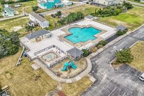 An aerial view of a residential area with a swimming pool, a playground, and a tennis court. - Dog-friendly, sound-front home with 2 sundecks, fireplace, & private hot tub (Buxton)