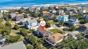 An aerial view of a coastal residential area with houses, a pier, and a beach. - Forever June 383: Near the beach w/deck! (Avon)