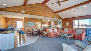 A spacious living area with a kitchen, a dining area, and a large window offering a view. - Brigadune 143: Dog Friendly, Ocean view, 3 lots from beach (Avon)