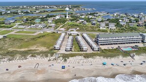 Une zone côtière dotée d’une plage, d’un grand complexe hôtelier et d’un port de plaisance.
