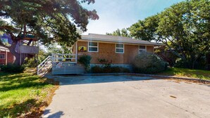 A two-story house with a front porch, a driveway, and a small front yard. - Waterfront House w/ Water View, Shared Pool, Private Washer/Dryer, & Free WiFi (Frisco)