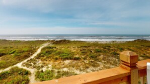 A wooden deck with a view of the ocean and a sandy path leading to the beach. - Oceanfront dog-friendly home with private hot tub, ocean-view sundecks, AC & W/D (Frisco)