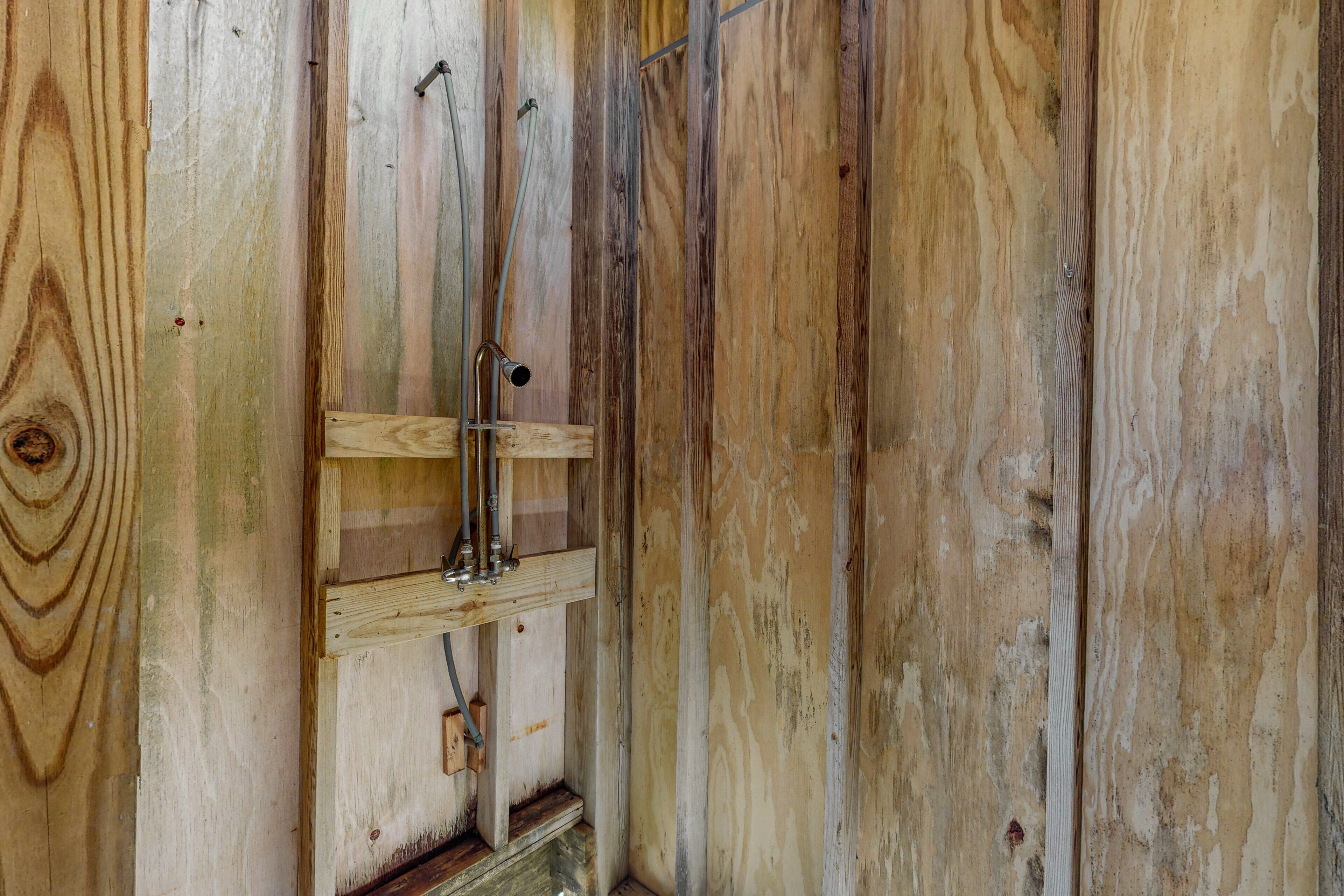 A wooden interior with exposed beams and a metal fixture.
