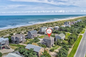 An aerial view of a coastal residential area with houses, a beach, and a road. - Hooked on Beach Life #16-AC: Dog-Friendly, Ocean View, Shared Pool (Avon)