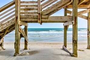 A wooden beach structure with a view of the ocean. - Beachfront condo with ocean views, balcony, WiFi, & shared grills (North Topsail Beach)