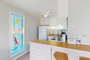 Fridge, microwave, oven, stovetop - Beachfront condo with ocean views, balcony, WiFi, & shared grills (North Topsail Beach)