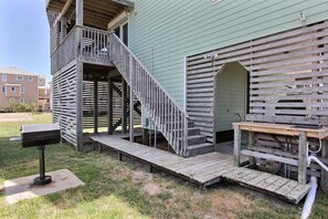 A wooden deck with a staircase leading to a balcony, a bench, and a mailbox. - Dog-friendly house with AC, W/D, private pool, & hot tub (Waves)