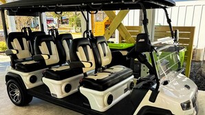 A golf cart with three seats, a storage compartment, and a windshield. - Anchor Forty-Five: Coastal home with large deck, close to beach and local attractions (Oak Island)