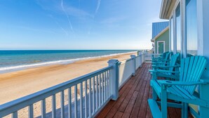 A wooden deck with a railing overlooking a beach. - Oceanfront, multi-level home with beach access, views, game room, & elevator (North Topsail Beach)