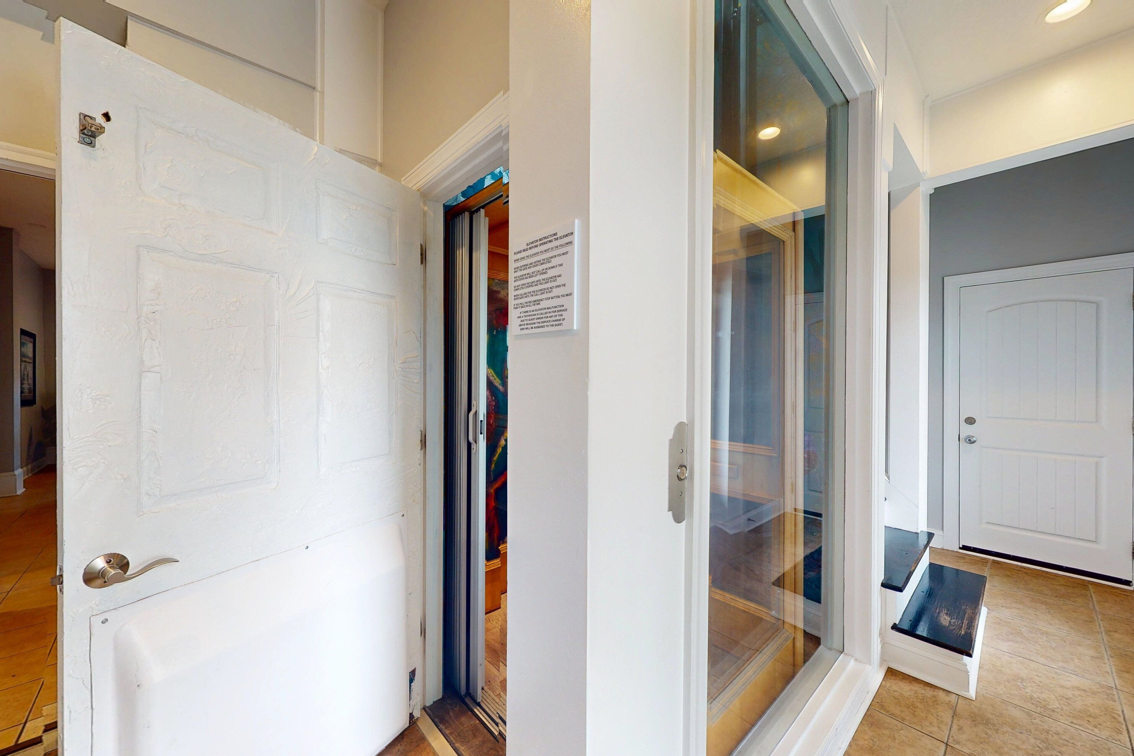 A hallway with a white door, a glass door, and a closed door with a sign.