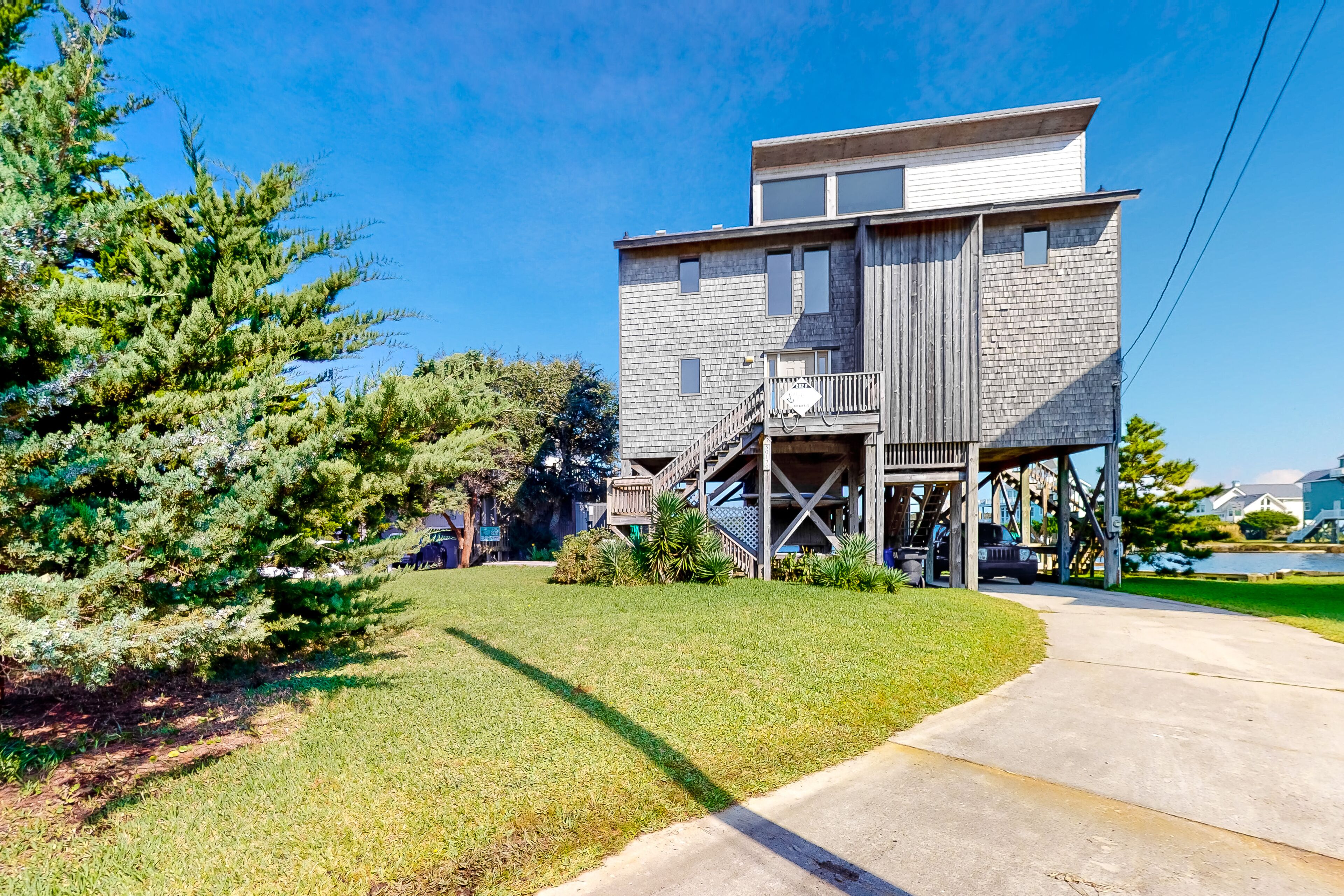 A two-story building with a wooden exterior and a balcony.