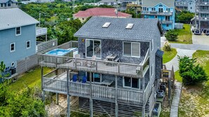 A two-story house with a balcony, a small pool, and a garage. - Oceanfront house w/private hot tub, balcony, washer/dryer, WiFi, central AC (Waves)