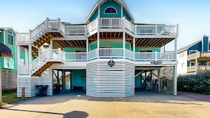 A multi-story building with a central atrium, balconies, and a covered entrance.