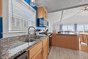 Fridge, microwave, oven, stovetop - Oceanfront home w/elevator, private hot tub, shared pool, beach access, & WiFi (Frisco)
