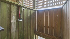 A wooden sauna with a bench and a showerhead. - Oceanfront home with direct beach access, community pool & private hot tub (North Topsail Beach)