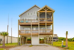 A two-story house with a balcony on the upper floor.