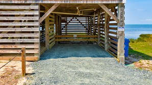 A wooden structure with a sloped roof and a sign indicating it is for wind therapy guests only. - Waterfront  house with pool, W/D, private hot tub, & AC (Frisco)