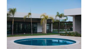 Un bâtiment moderne avec une piscine en premier plan.