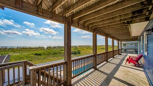 A wooden deck with a view of the beach and ocean. - Dog-friendly oceanfront home with private outdoor pool, hot tub & central AC (Waves)