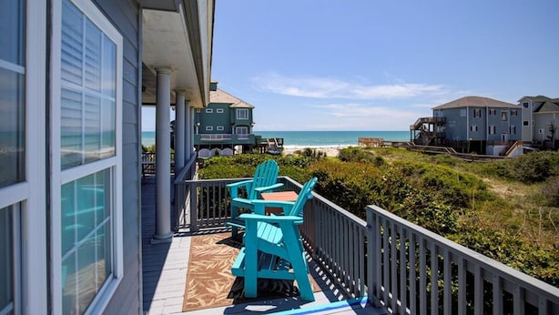 A balcony with two turquoise Adirondack chairs overlooking a beach. - Ocean View Duplex in Hampton Colony - Community Pool & Just Steps to the Beach!! (North Topsail Beach)
