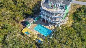 A multi-story house with a swimming pool, surrounded by dense greenery. - Dog-friendly ocean- & sound-view home with private pool, hot tub, & central AC (Avon)