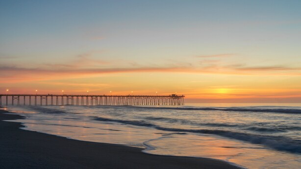 A pier extending into the ocean at sunset. - Sunset Village 16-D: Top Floor, Pool, Hot Tub (Sunset Beach)