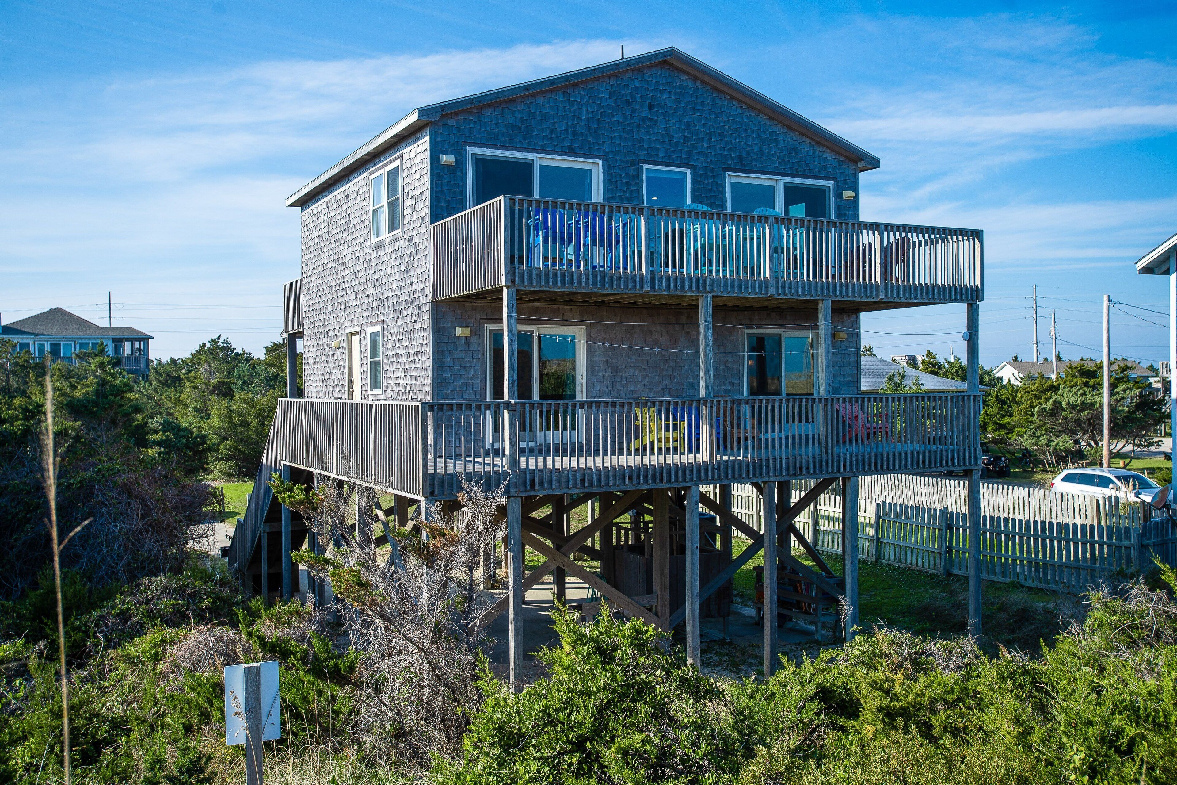 A two-story house with a balcony on the upper floor.
