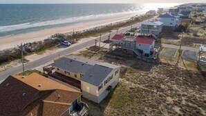 A coastal residential area with houses, a beach, and a road. - Oceanview home with direct beach access just across the street (Surf City)
