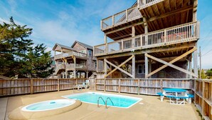 A wooden building with a pool and picnic tables. - Lovely home with private pool, decks, amazing ocean view, & W/D (Hatteras)
