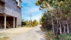 A gravel road leading to a wooden building with a porch and a sign that reads "CEAT". - Lovely home with private pool, decks, amazing ocean view, & W/D (Hatteras)