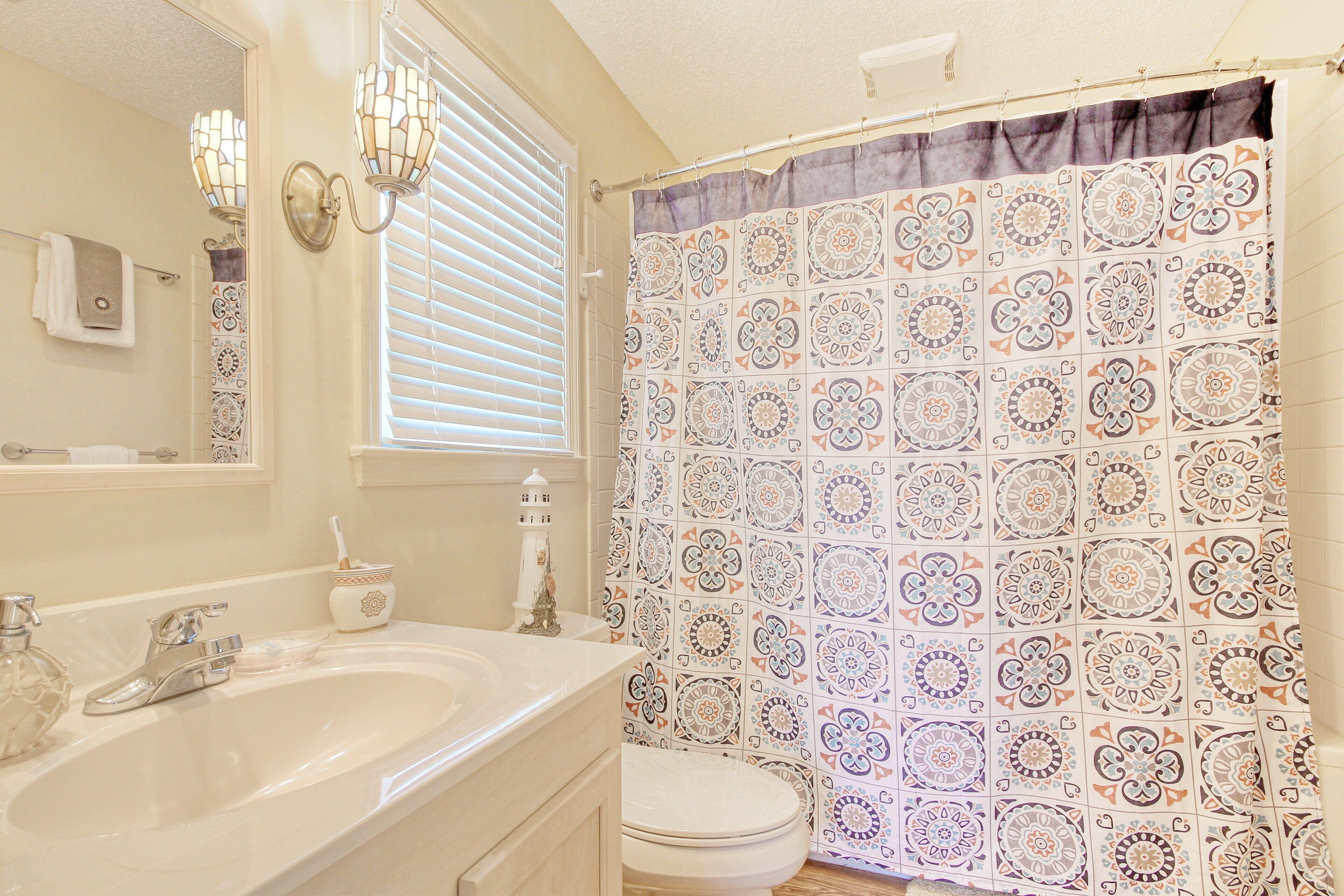 A bathroom with a large bathtub, a sink, and a toilet.