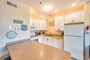 Fridge, microwave, oven, stovetop - Dog-friendly oceanfront condo with balcony, outdoor pool, hot tub, and central AC (Hatteras)