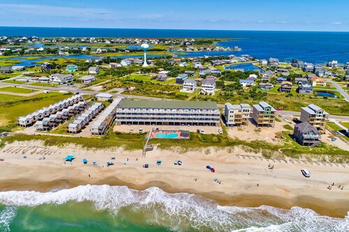 Dog-friendly oceanfront condo with balcony, outdoor pool, hot tub, and central AC