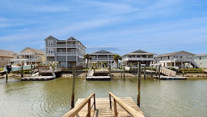 A waterfront property with multiple buildings, docks, and boats.