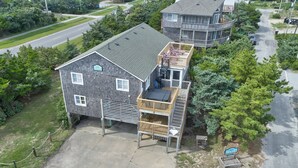 A two-story house with a balcony and a deck. - Twin Tides #14-AC: Semi-Oceanfront, Dog-Friendly, Shared Pool, Hot Tub (Avon)