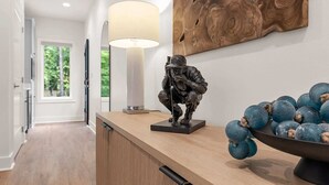A modern interior with a wooden reception desk, a sculpture, and a bowl of blueberries. - Reunion Resort Studio Unit 113A (Hot Springs Village)