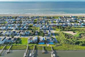 Aerial view - Custom home on the Intracoastal with water views, pool, dock, & decks (Holden Beach)