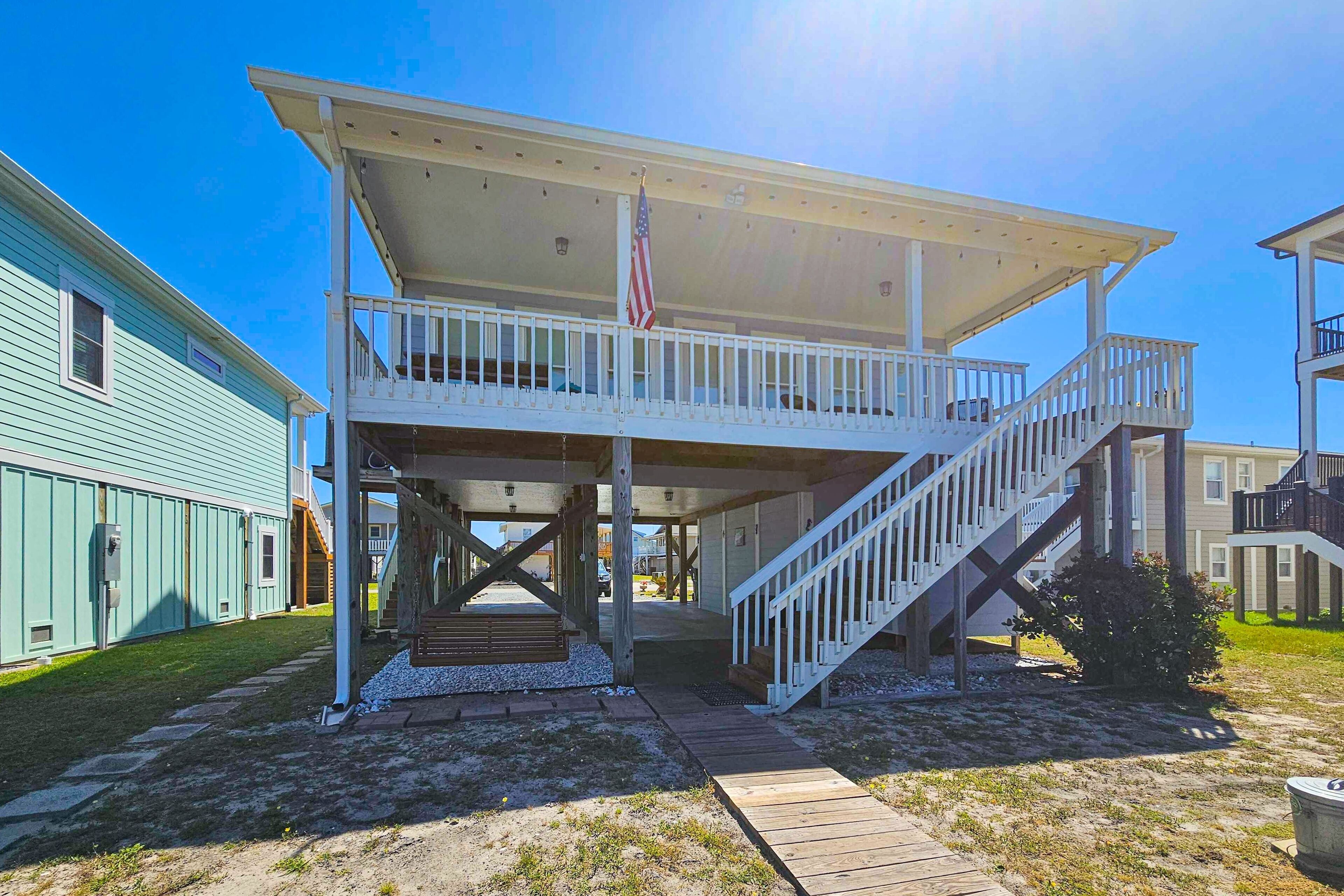 A two-story building with a balcony and a staircase.
