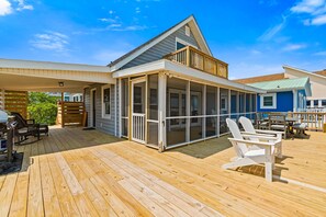 Outdoor dining - Waterfront home with wrap-around deck, two blocks from ocean (Holden Beach)