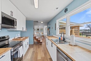 Fridge, microwave, oven, stovetop - Waterfront home with wrap-around deck, two blocks from ocean (Holden Beach)